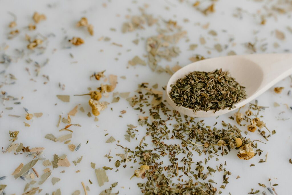 Close-Up Shot of dried herbs on wooden spoon