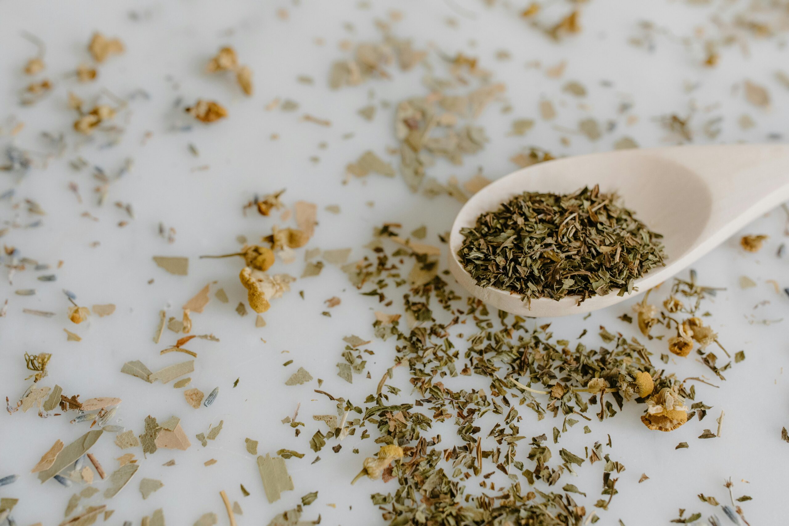 Close-Up Shot of dried herbs on wooden spoon