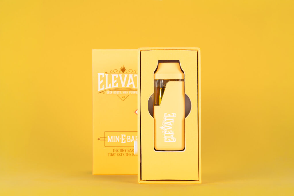 Picture of a Yellow Min-E-Bar Package and Vape on a Yellow Background